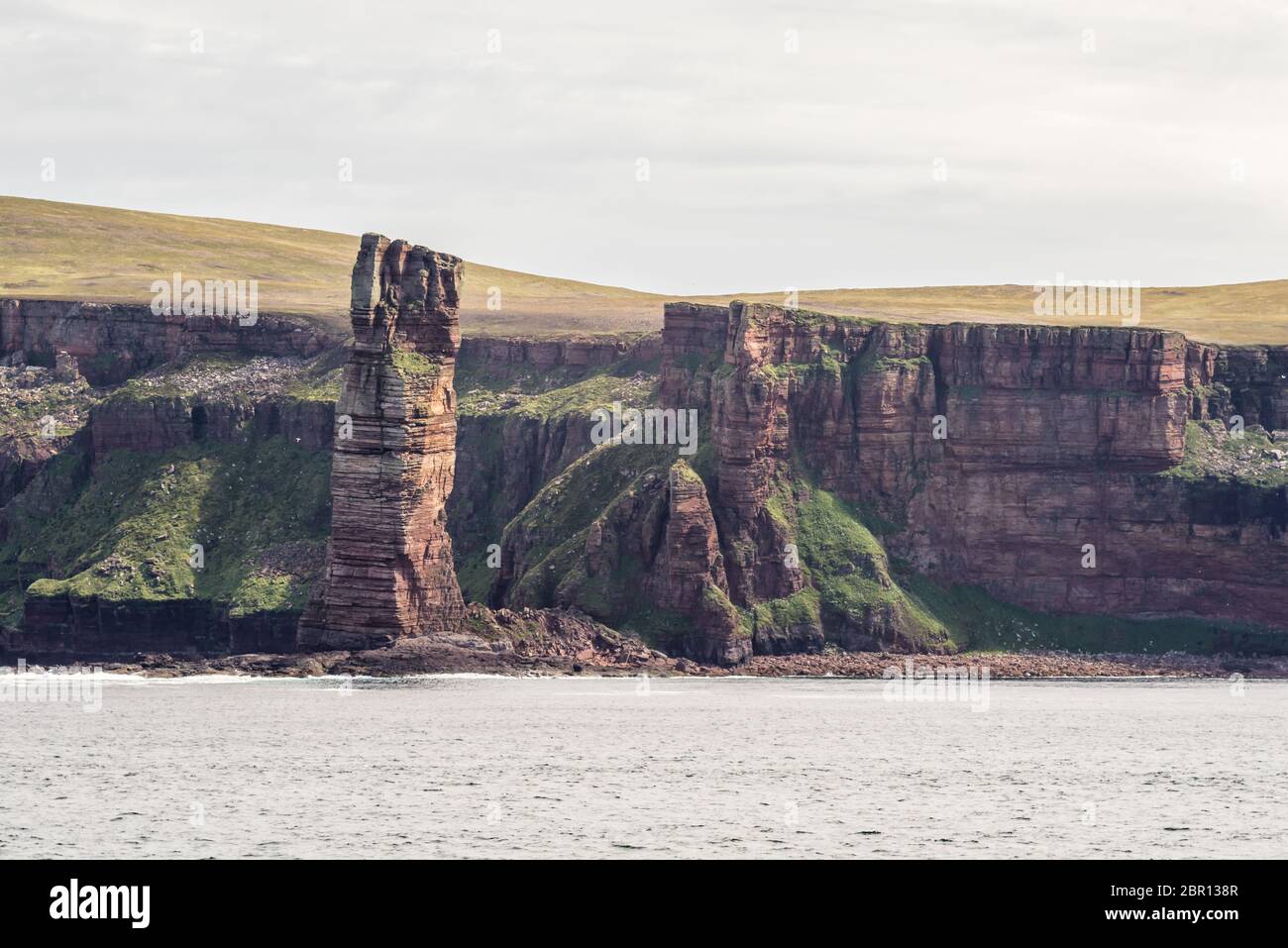 ocean view of the Old Man of Hoy, a tall sandstone stack at the coast between Stromness and Scrabster at Orknay in Scotland, Uk. Famous climbing place Stock Photo