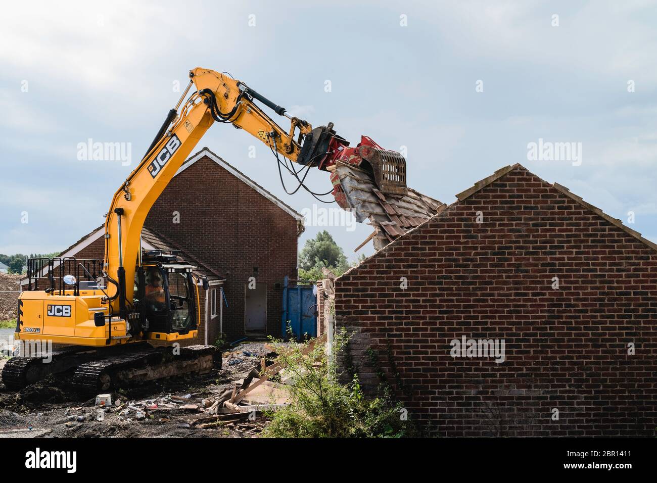 Heavy machinery demolishes private house to make way for development of new Lidl supermarket along Minster Way in Beverley, UK. Stock Photo