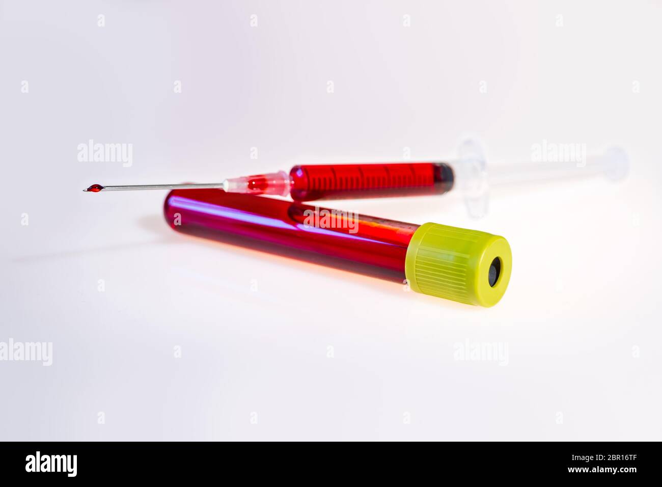 Syringe and test tube with blood isolated on white background Stock ...