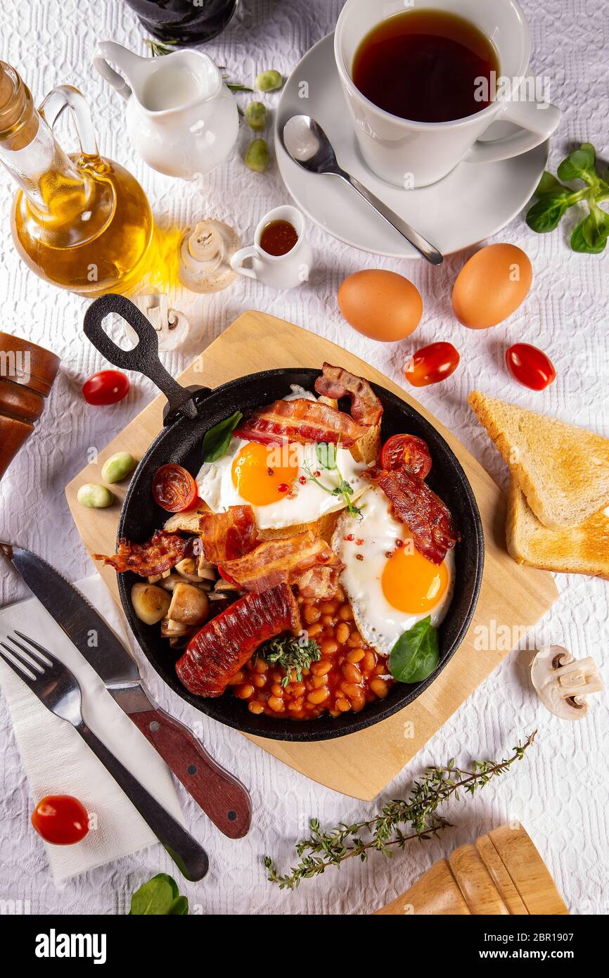 Traditional Full English Breakfast served with a cup of tea Stock Photo
