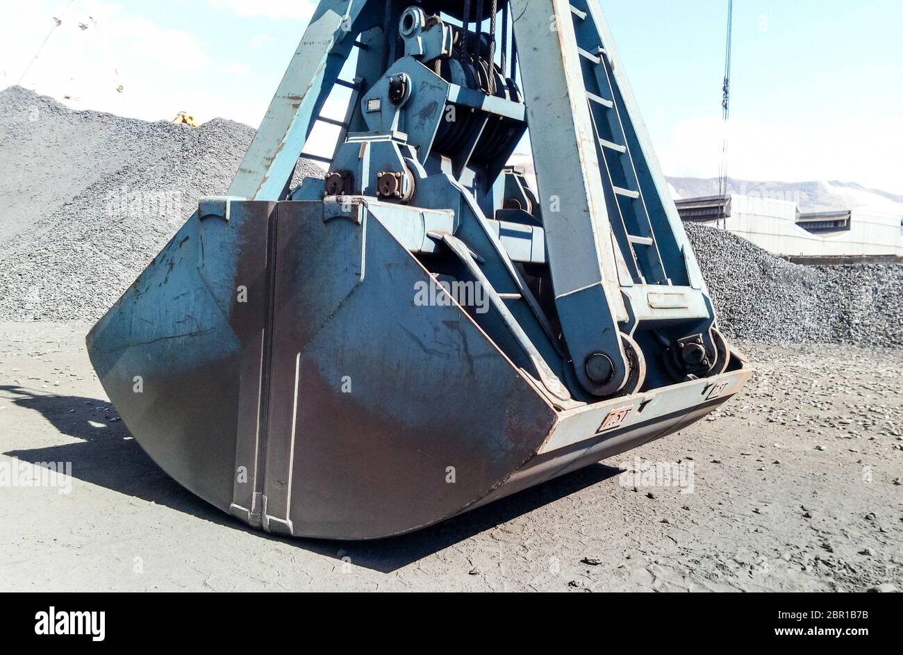 Clamshell bucket in the cargo port. Bucket for loading coal. Stock Photo