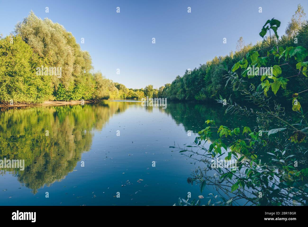 Blue lake in the autumn forest at sunset Stock Photo - Alamy