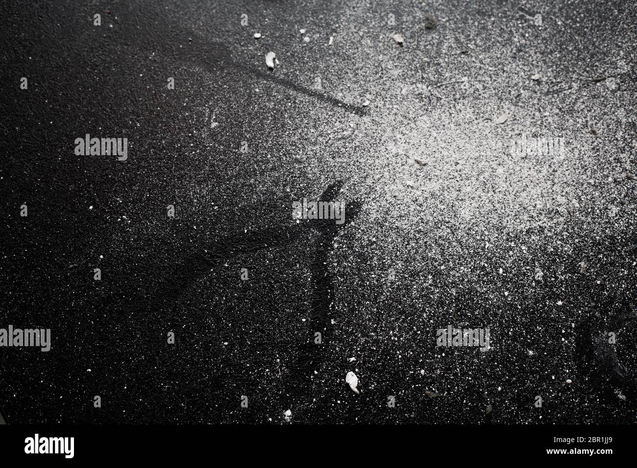 Traces of tools on a black table dusted with white dust Stock Photo - Alamy