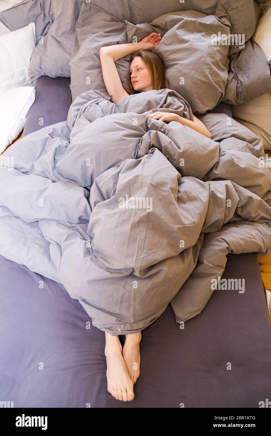 Woman with pillow under legs hires stock photography and images Alamy
