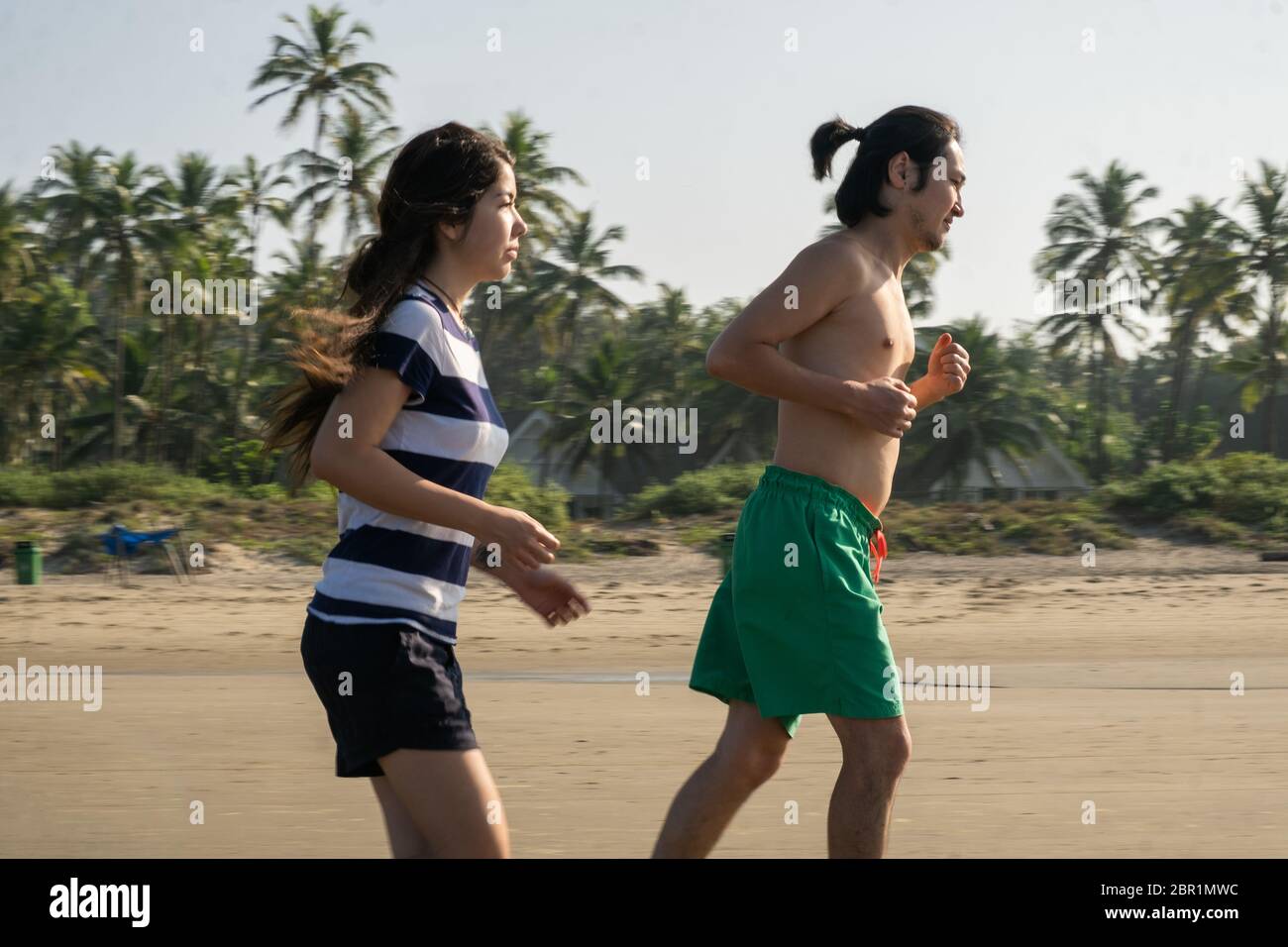 Couple running at the Vagator Beach, Goa, India Stock Photo