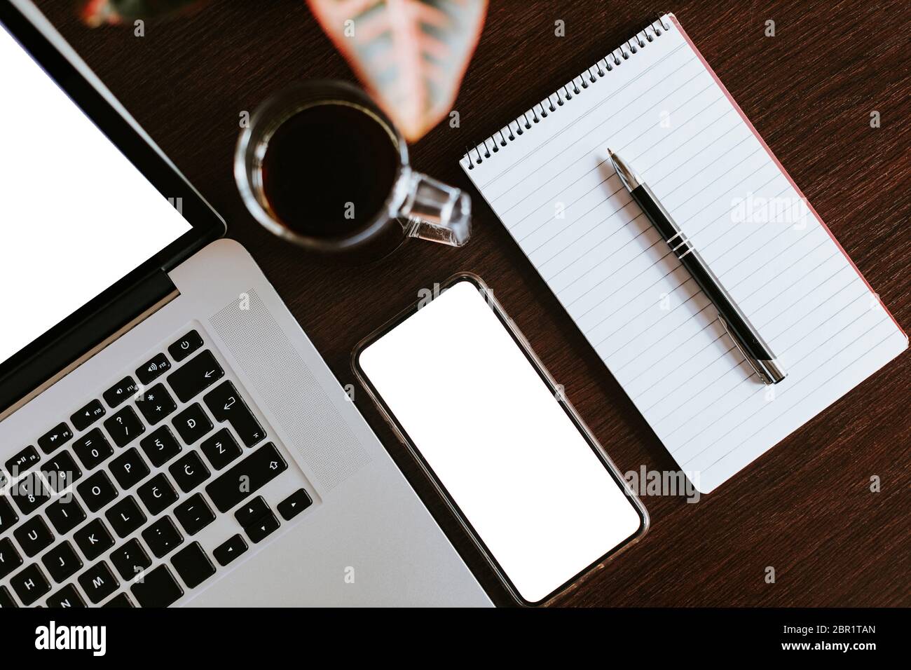 layout of laptop and phone with pen planning notebook. Office workplace ...