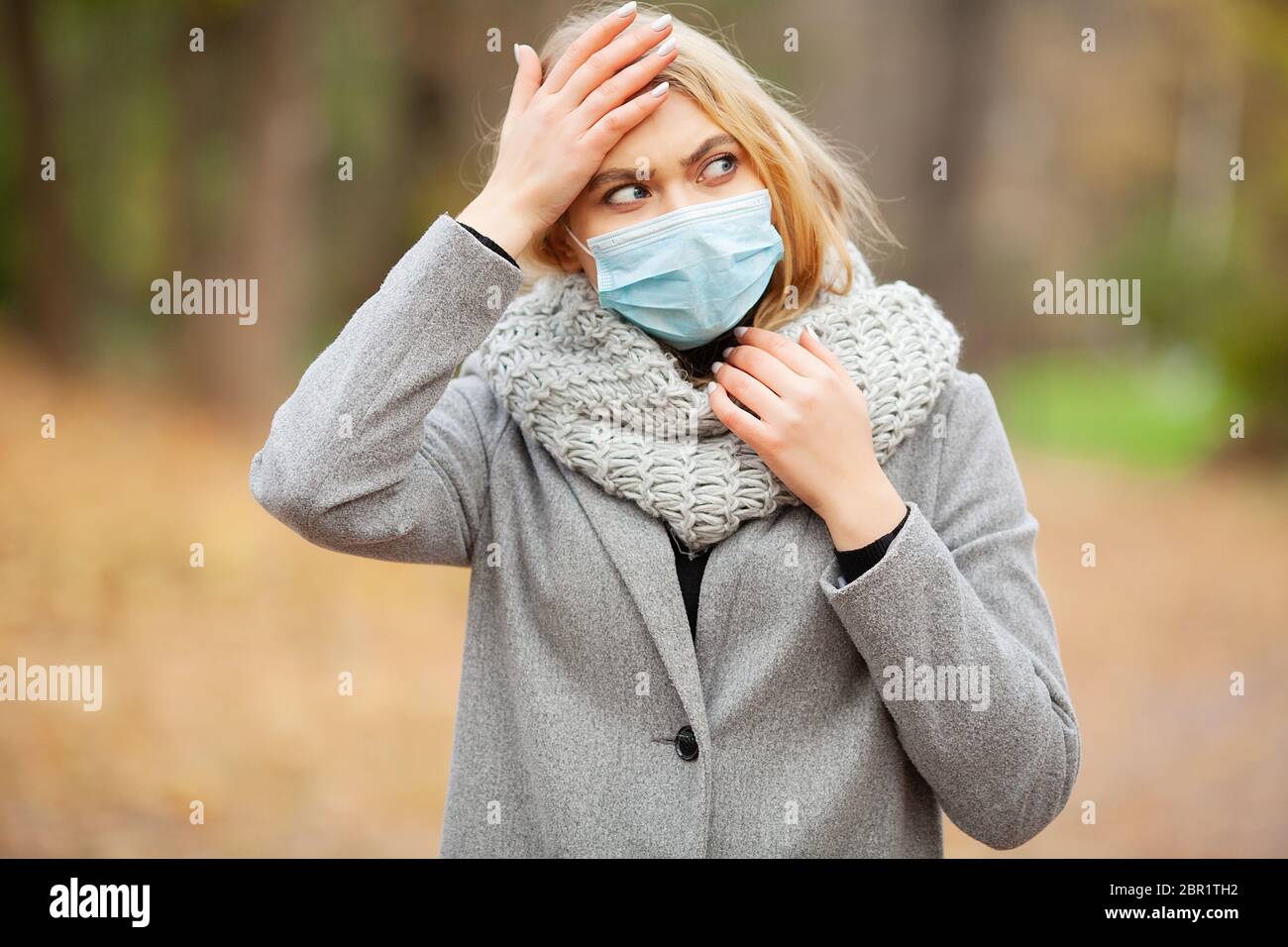Woman Cold Mask Cold and flu. Woman with a medical face mask at outdoor Stock Photo - Alamy