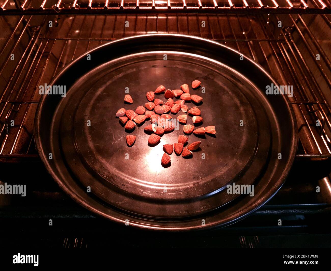 Almonds roasting in an oven Stock Photo Alamy