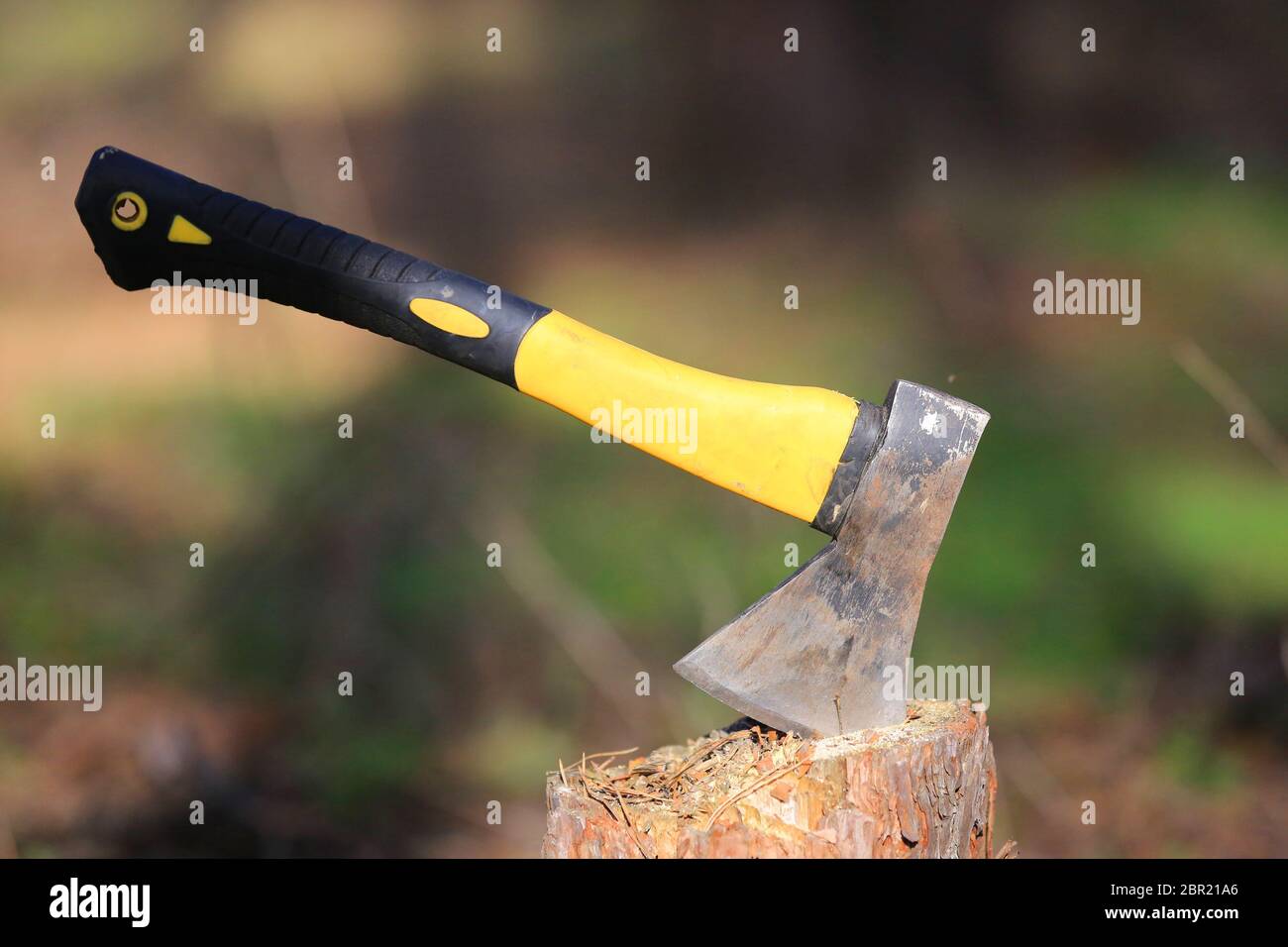 abstract axe with yellow handle grip in wooden chop Stock Photo Alamy