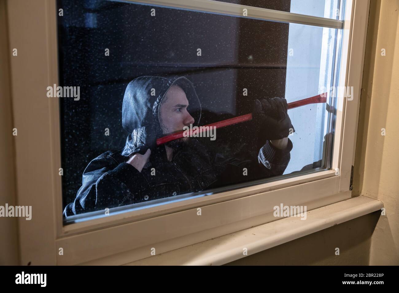 Thief Trying To Break The Window With Crowbar At Night Stock Photo - Alamy