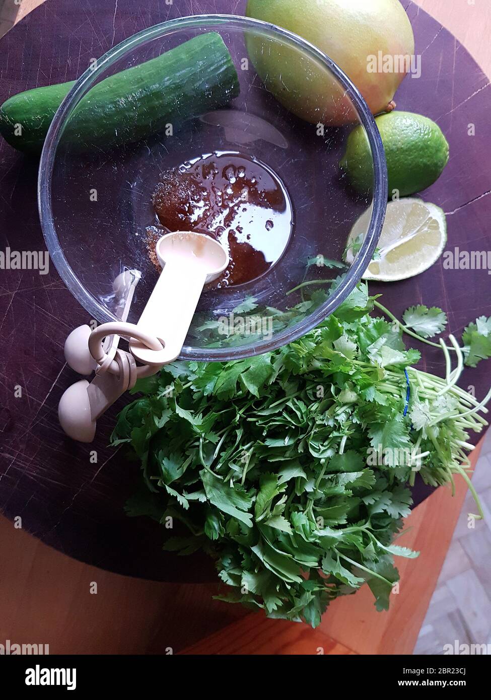 Preparation of recipe ingredients. Bunch of fresh coriander, cucumber