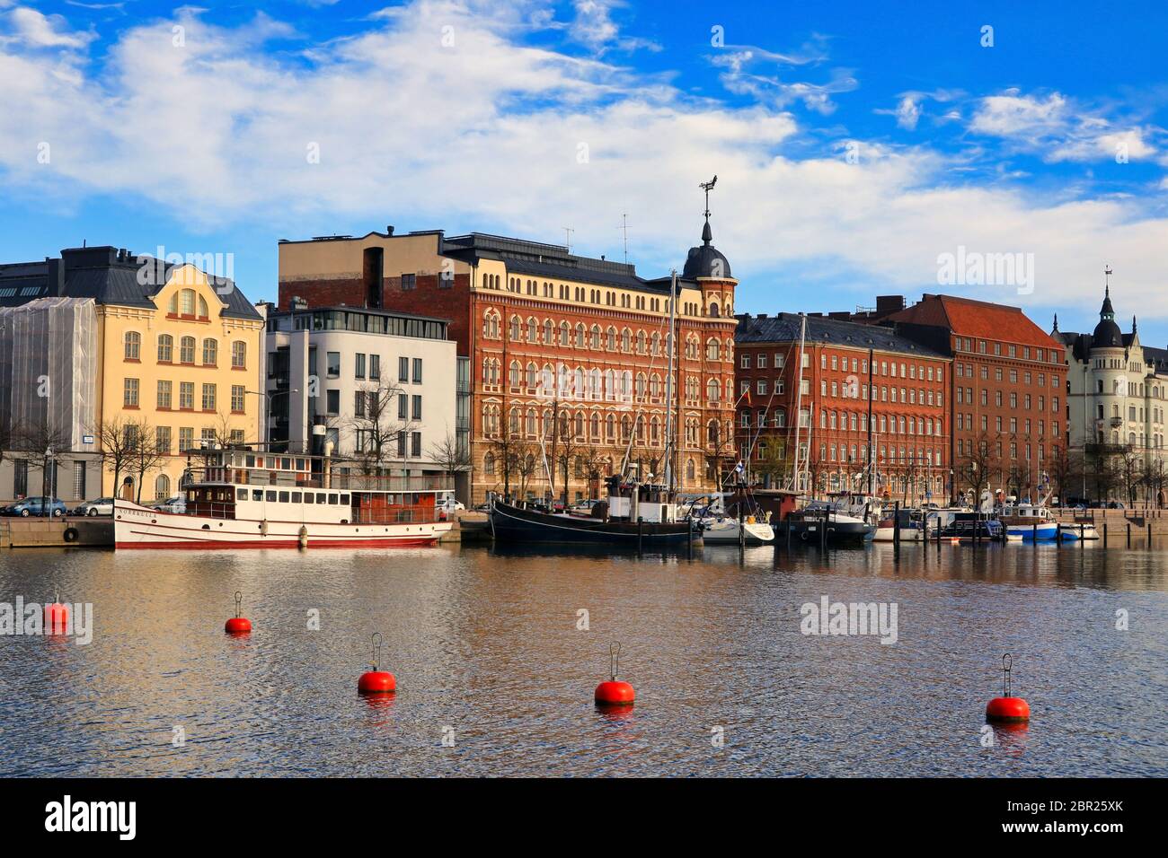 Pohjoisranta embankment on a beautiful day with historic architecture, moored recreational boats and red buyos. Helsinki, Finland. May 2020. Stock Photo