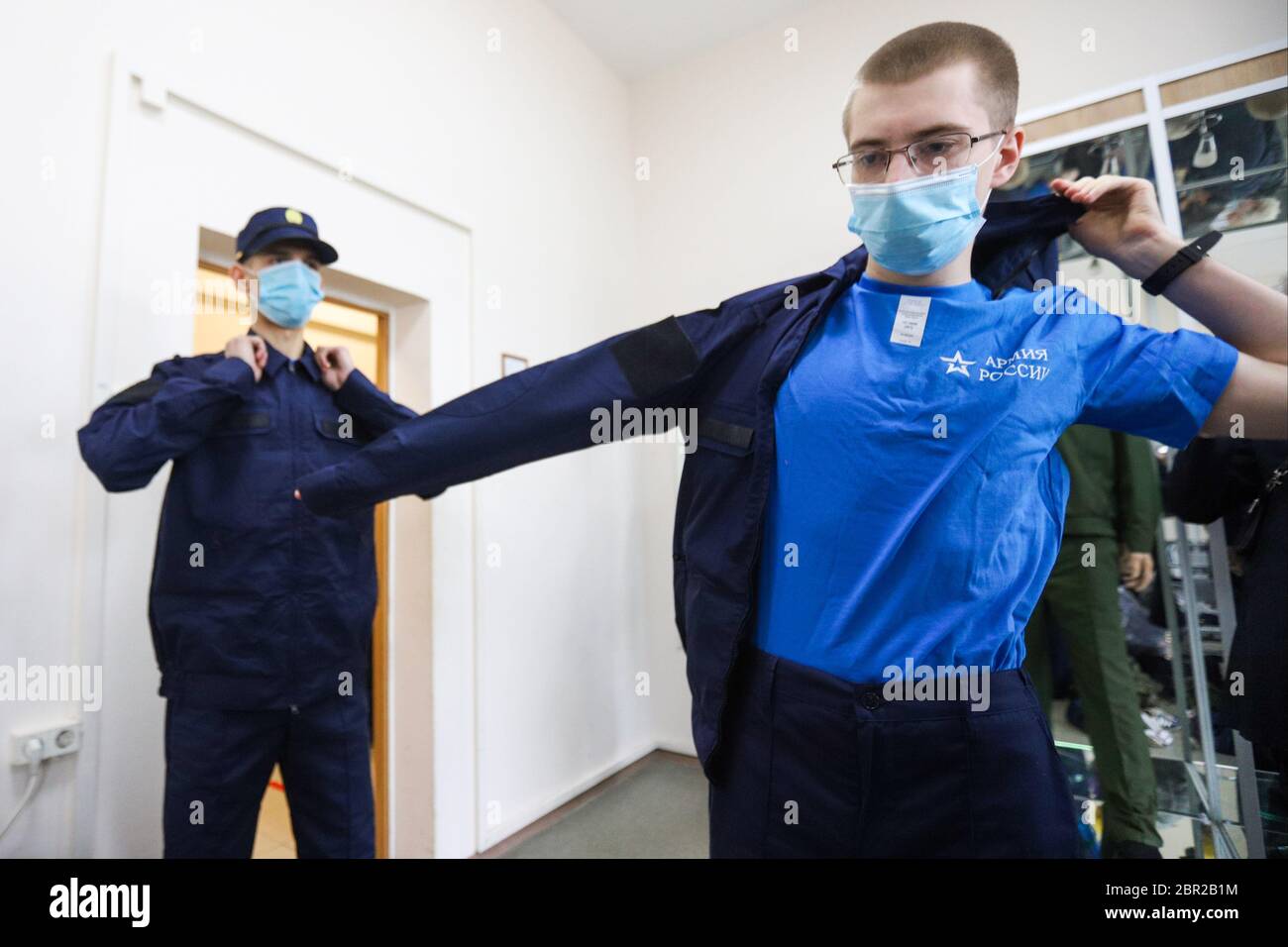 Russian recruits wearing face masks are seen changing into their military uniform at the recruitment center. President Vladimir Putin declared a send to the army of 135,000 people during the spring call-up in Russia which started on the 20th of May. All recruits tested for Covid-19 infection, will be quarantined for 14 days in their military units. Stock Photo