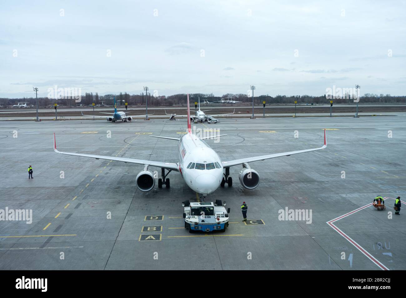 View Of The Aircraft Parking At The Airport. The Plane Is Being Prepared  For Departure By Airport Staff Stock Photo - Alamy