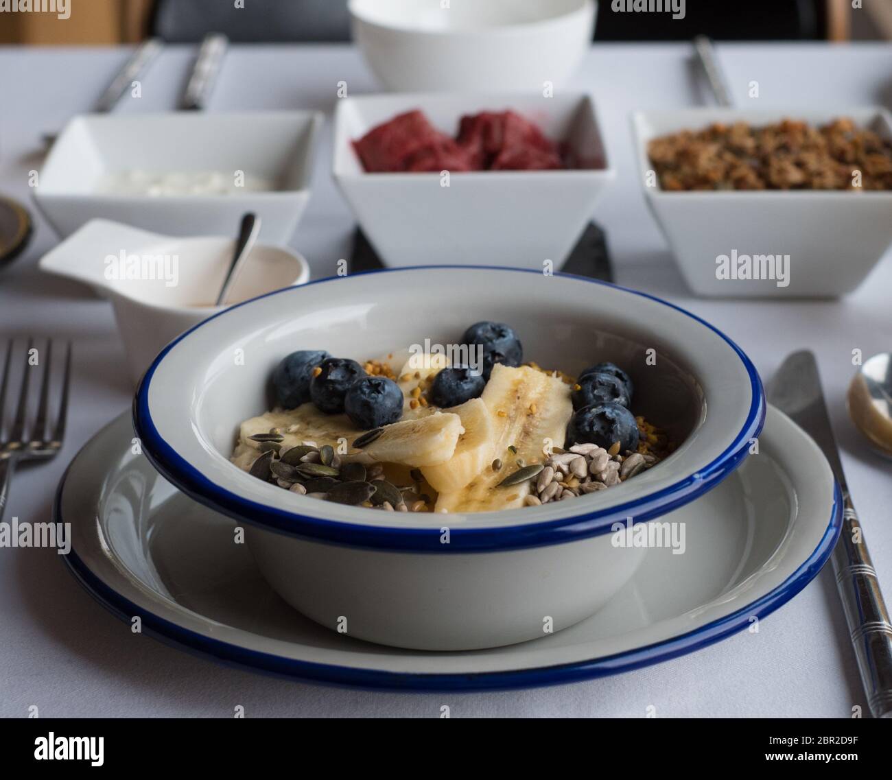 Porridge with blueberries,  banana and seeds Stock Photo