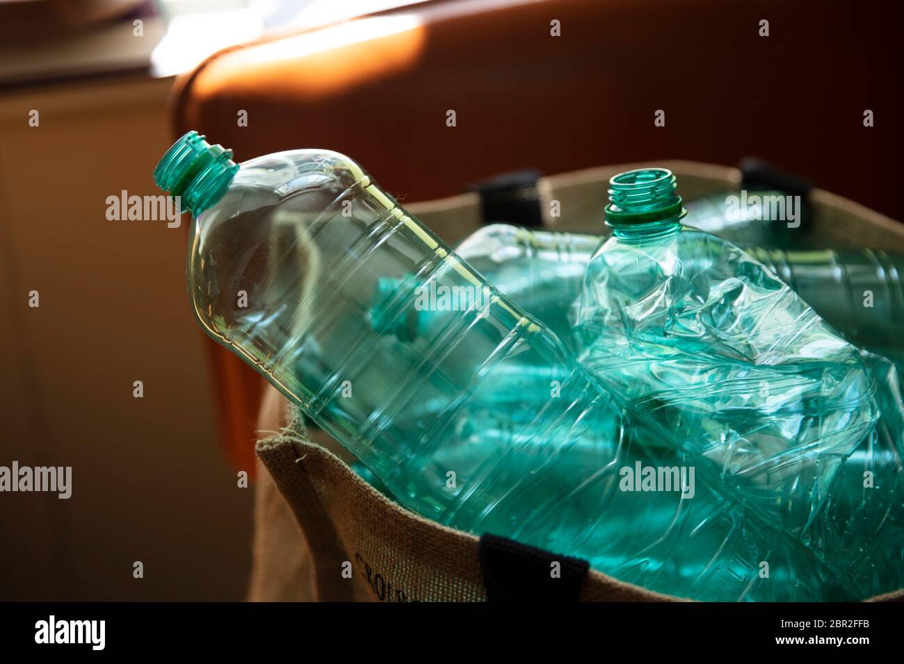 A collection of used green plastic bottles ready to be recycled Stock Photo