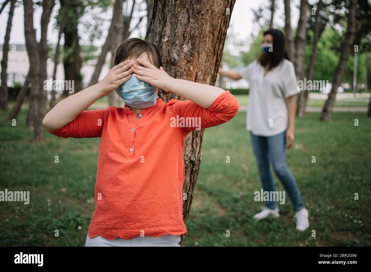 Free Vector  Little kids playing hide and seek in park playing game with  friends outdoor in vacations boy counting boys hiding begind tree girl  running to hide