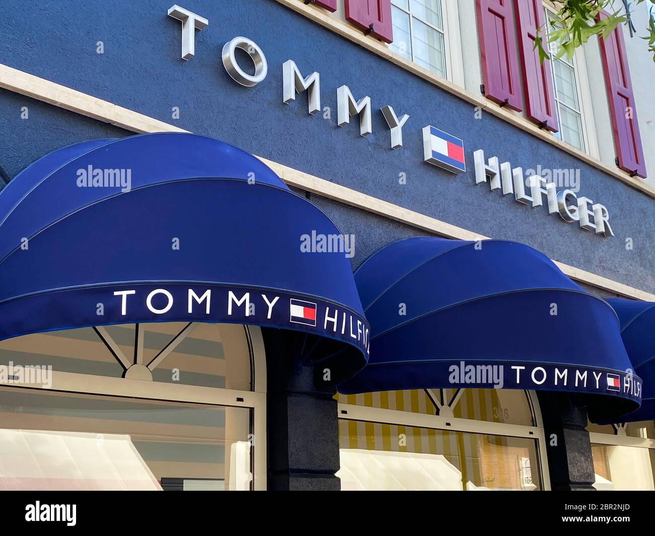 Roermond, Netherlands - May 19. 2020: View on facade with logo lettering of Tommy  Hilfiger fashion company at shop entrance Stock Photo - Alamy