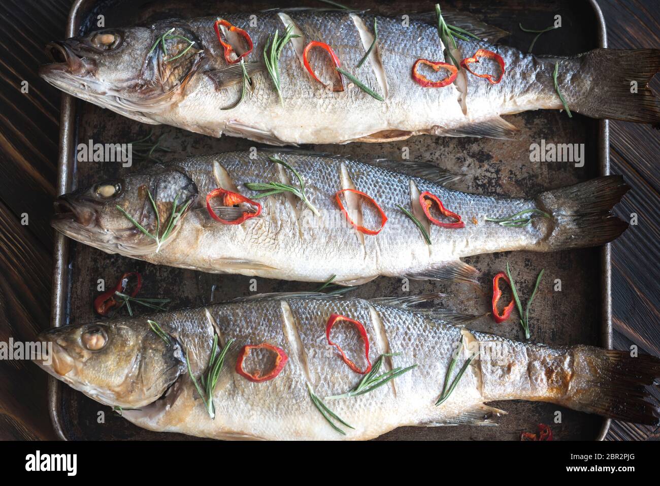 Baked sea bass with lime and chilli pepper Stock Photo Alamy