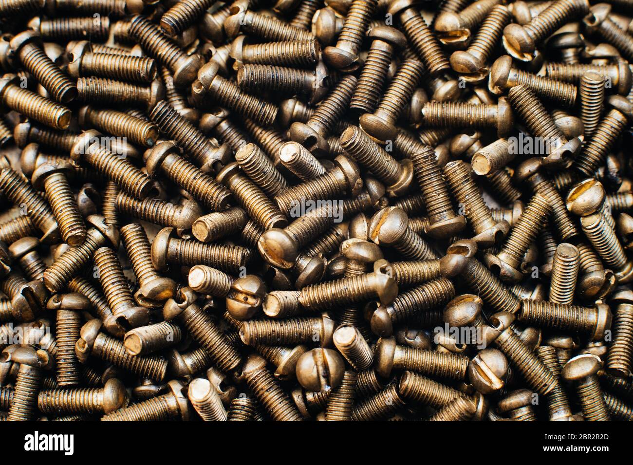 Close-up, macro. Old Soviet brass pan head screw with a flat head  screwdriver. Texture, background of screws. Gold color screws Stock Photo -  Alamy