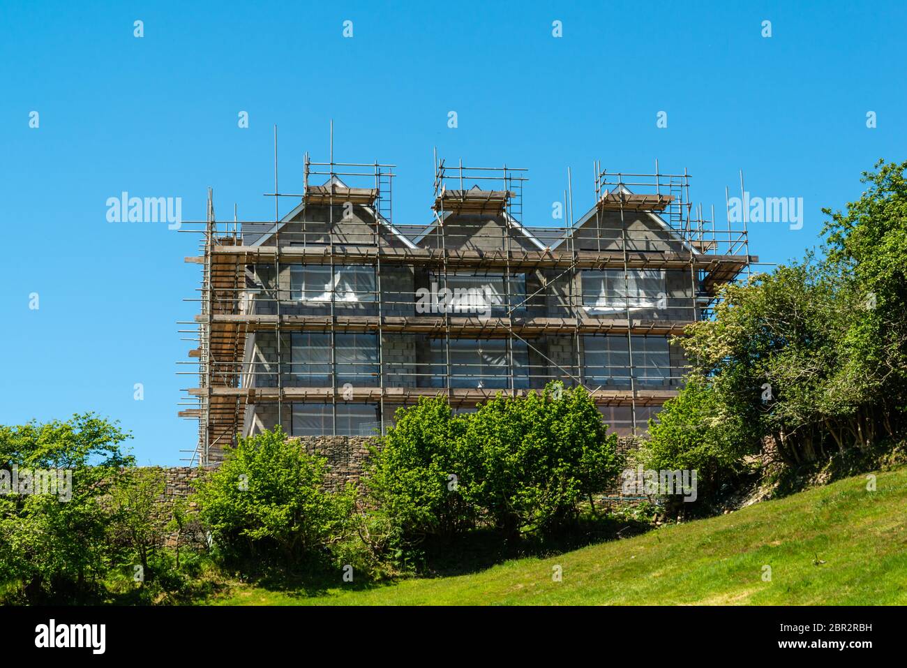 House under construction covered in scaffolding Stock Photo