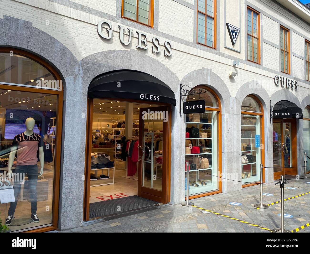 Roermond, Netherlands - May 19. 2020: View on facade with logo lettering of  Guess fashion company at shop entrance Stock Photo - Alamy