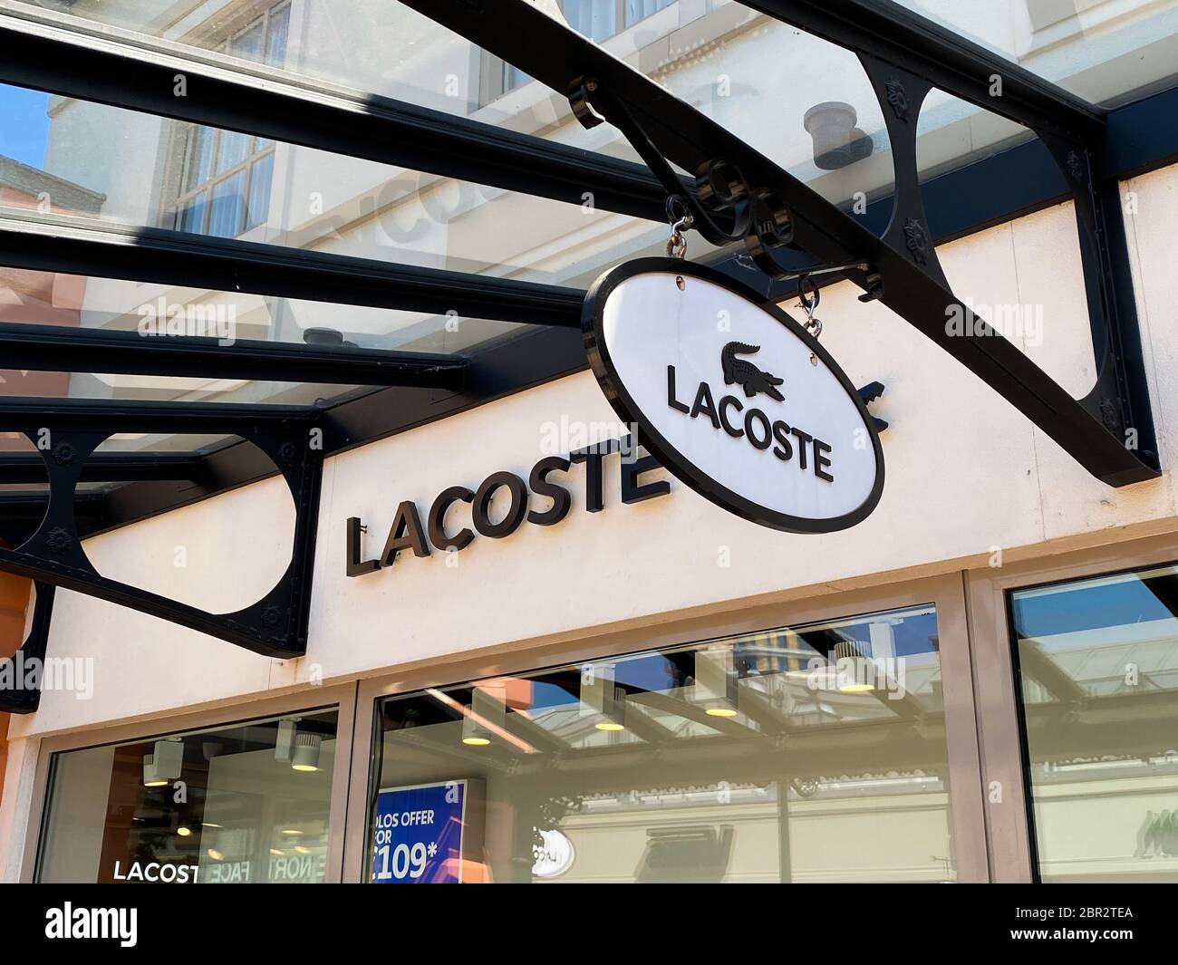 Roermond, Netherlands - May 19. 2020: View on logo lettering of French Lacoste company at shop entrance Stock Photo