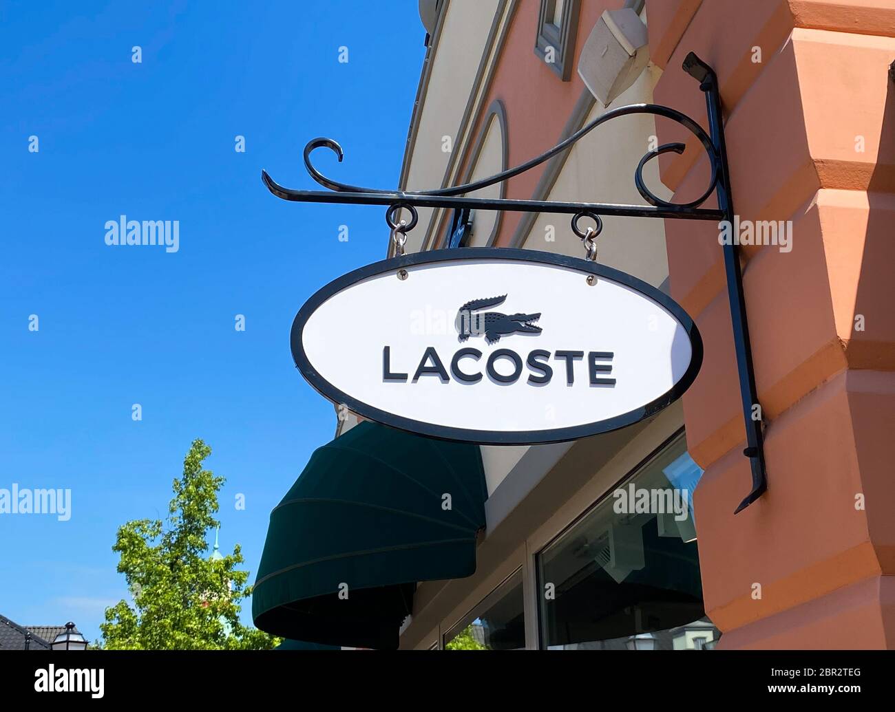 Roermond, Netherlands - May 19. 2020: View on logo lettering of French Lacoste company at shop entrance Stock Photo