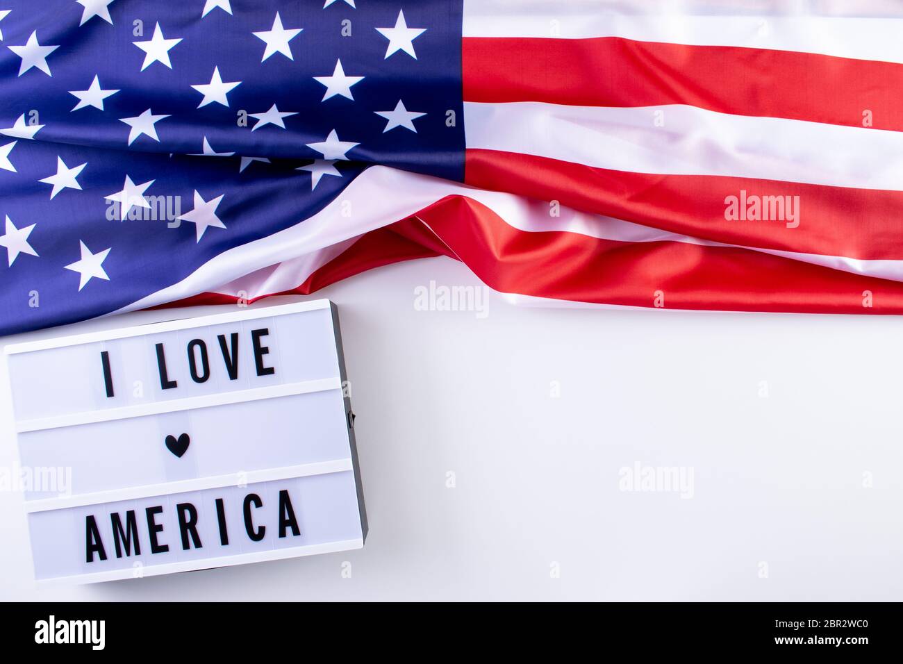I LOVE AMERICA text in a light box with an American Flag on wthite background. Happy Memorial