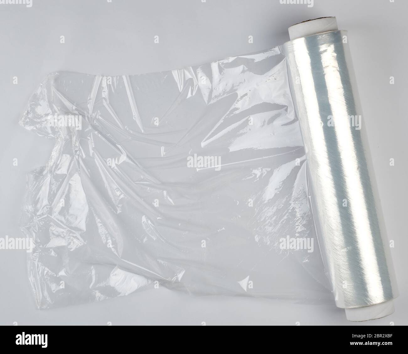 https://c8.alamy.com/comp/2BR2XBF/big-roll-of-wound-white-transparent-film-for-wrapping-food-top-view-2BR2XBF.jpg