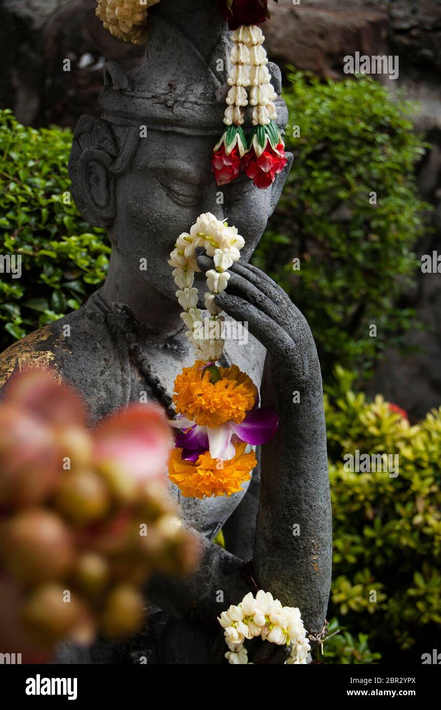 A religious concrete statue at the Reclining Buddha temple, in Bangkok. Stock Photo