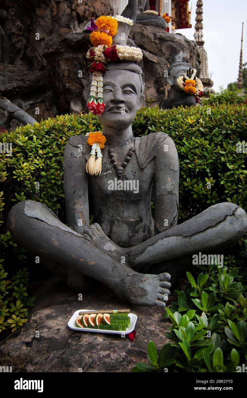 A religious concrete statue at the Reclining Buddha temple, in Bangkok. Stock Photo