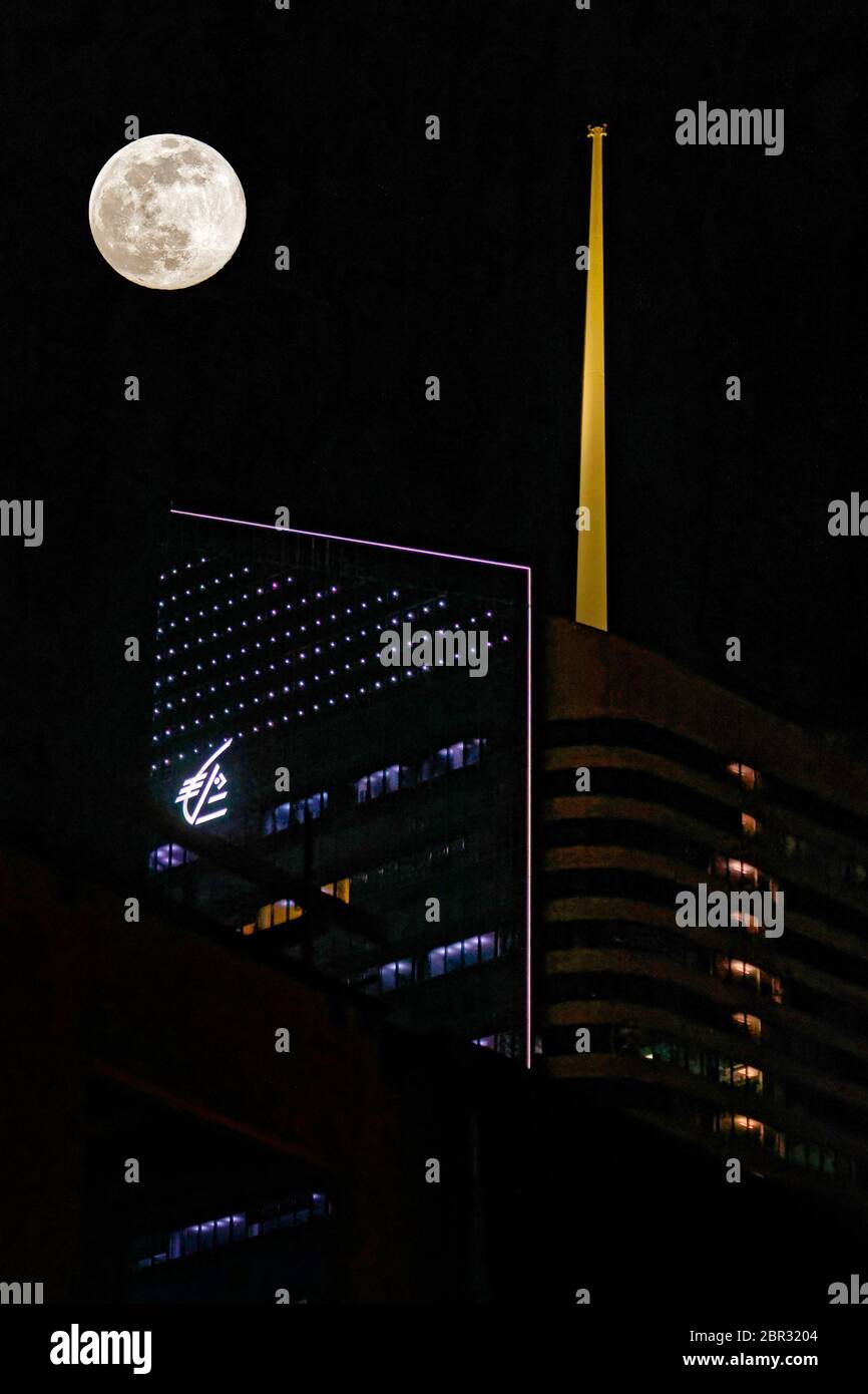 LYON, FRANCE, April 7, 2020 : Full moon over the Incity tower in Lyon city center during a dark night of confinement. Stock Photo