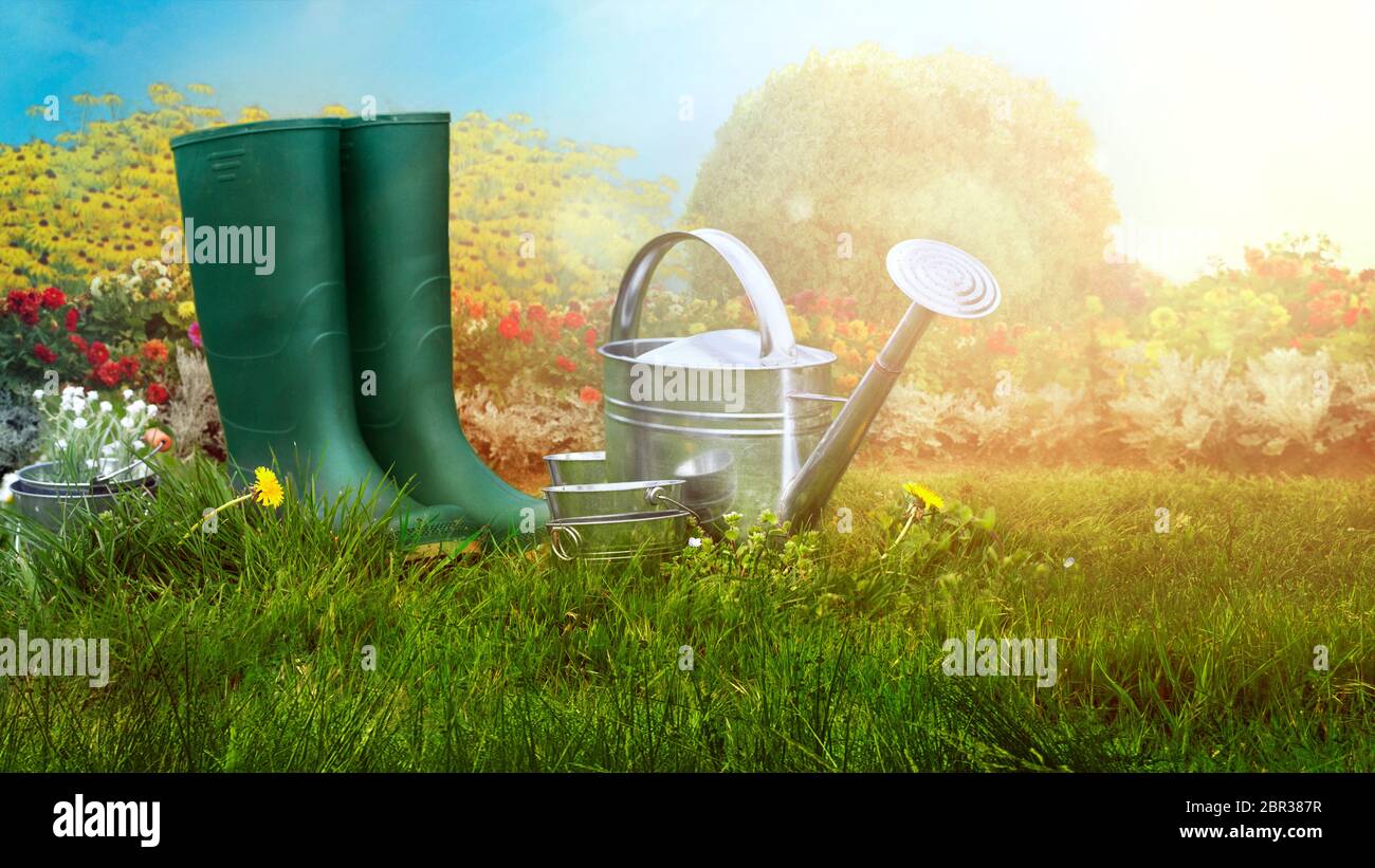 Spring garden. Boots and gardening tools in green grass. Garden concept Stock Photo