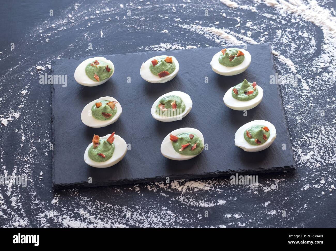 Spinach and bacon deviled eggs Stock Photo