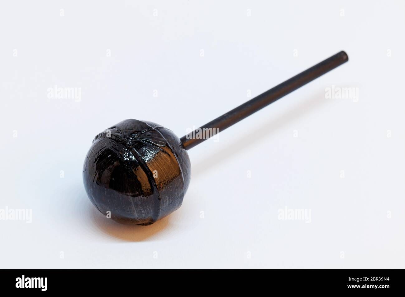 black licorice lollipop on white background Stock Photo Alamy