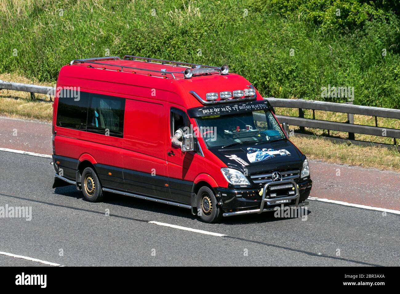 Isle of Man TT Road Racing, red black Mercedes Benz Sprinter Van. Custom,  rare lifestyle, modified, personalization, unusual personalised motors,  modding, bespoke. Vehicular traffic moving vehicles, driving vehicle on UK  roads, motors,