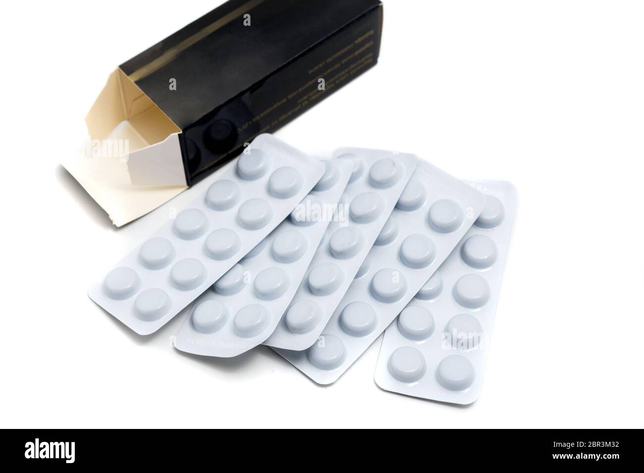 pills in sheets and black box packaging on white background Stock Photo