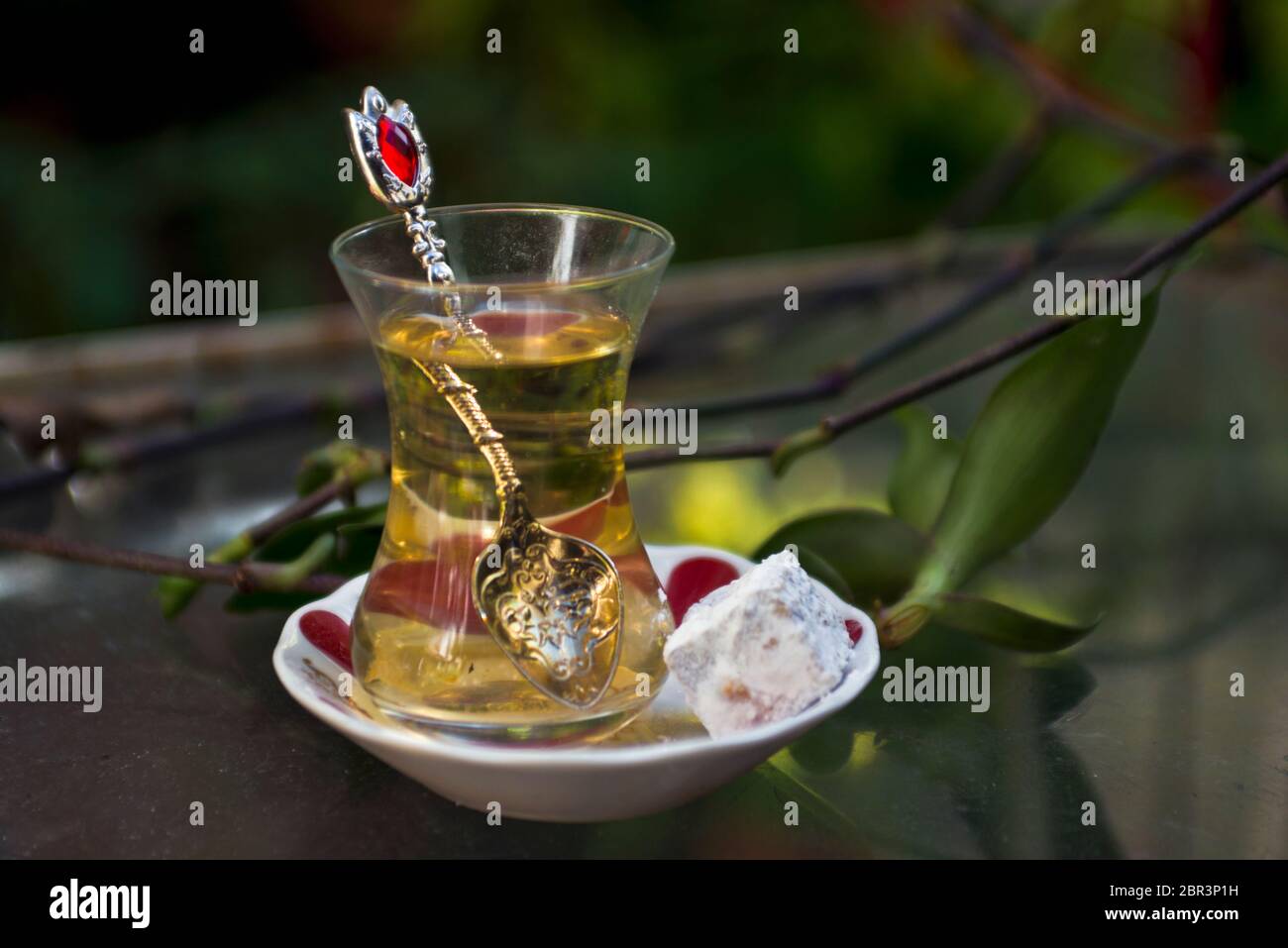 Turkish apple tea and sweet (turkish delights), served on a glass table
