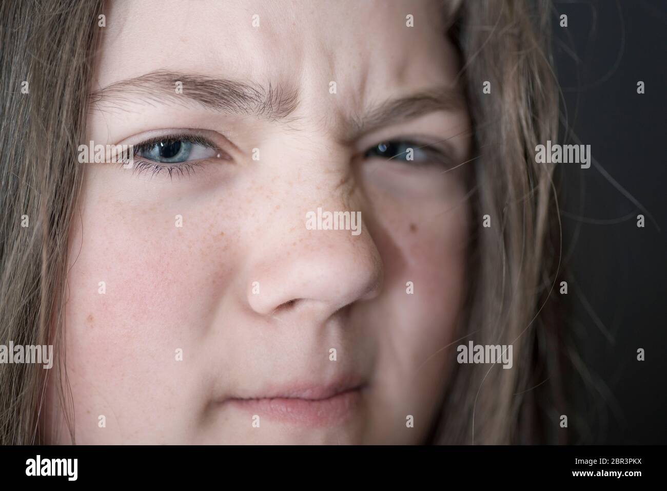 girl face grimace closeup portrait, focus on eye Stock Photo