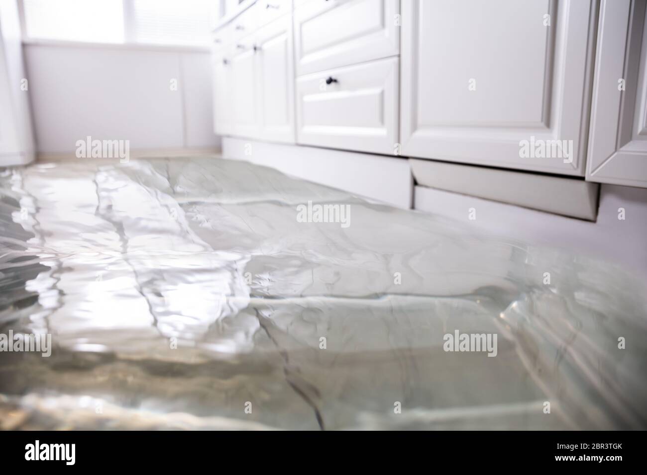 Close-up Of Flooded Floor In Kitchen From Water Leak Stock Photo