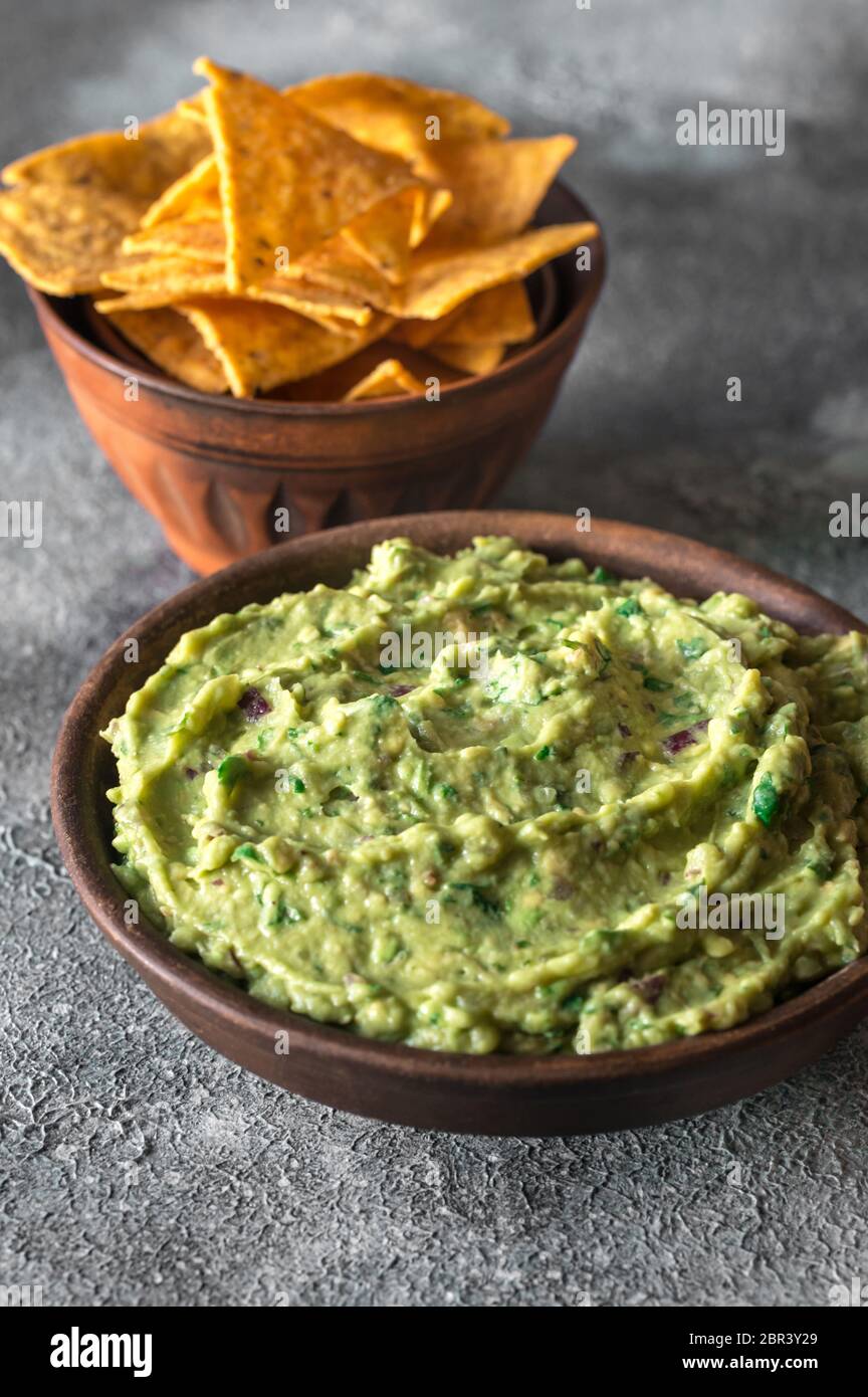 Guacamole in bowl with tortilla chips Stock Photo Alamy