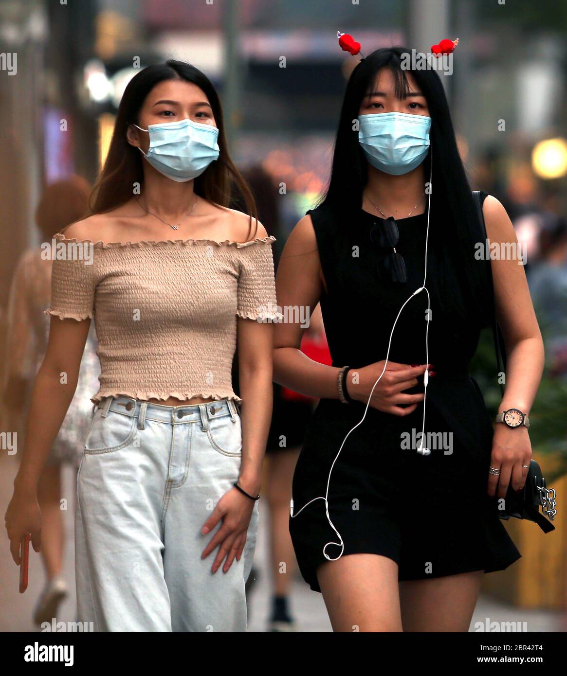Beijing, China. 20th May, 2020. Chinese continue wearing protective face masks in public as they visit a popular, international shopping plaza in Beijing on Wednesday, May 20, 2020. Wuhan, a city of 11 million, where the Covid-19 pandemic originated, reported new cases over the weekend, its first new infections in over a month. China is aggressively investigating the new cluster, announcing a plan to test the entire city in 10 days. Photo by Stephen Shaver/UPI Credit: UPI/Alamy Live News Stock Photo
