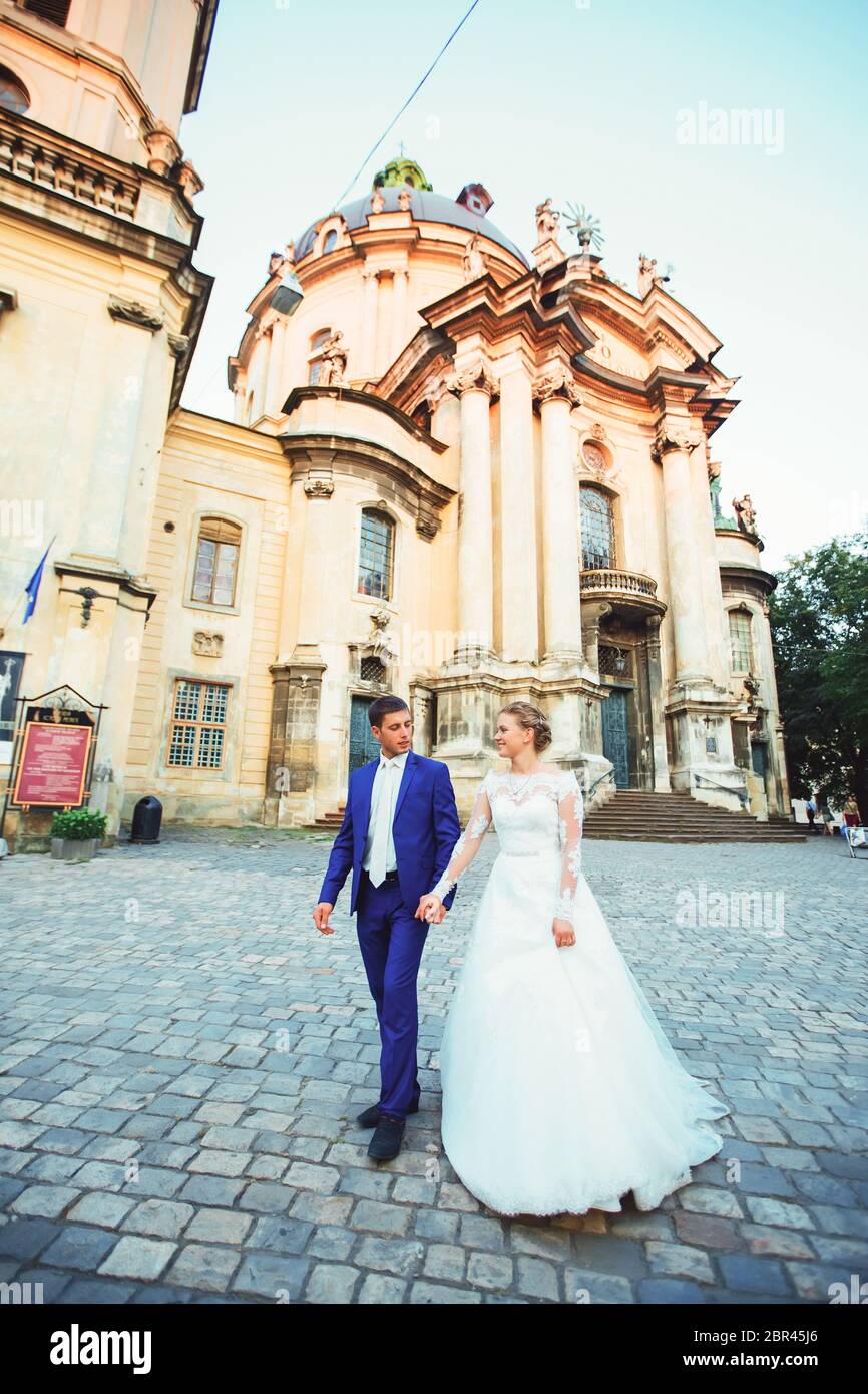 bride and groom walk around the old town Stock Photo - Alamy