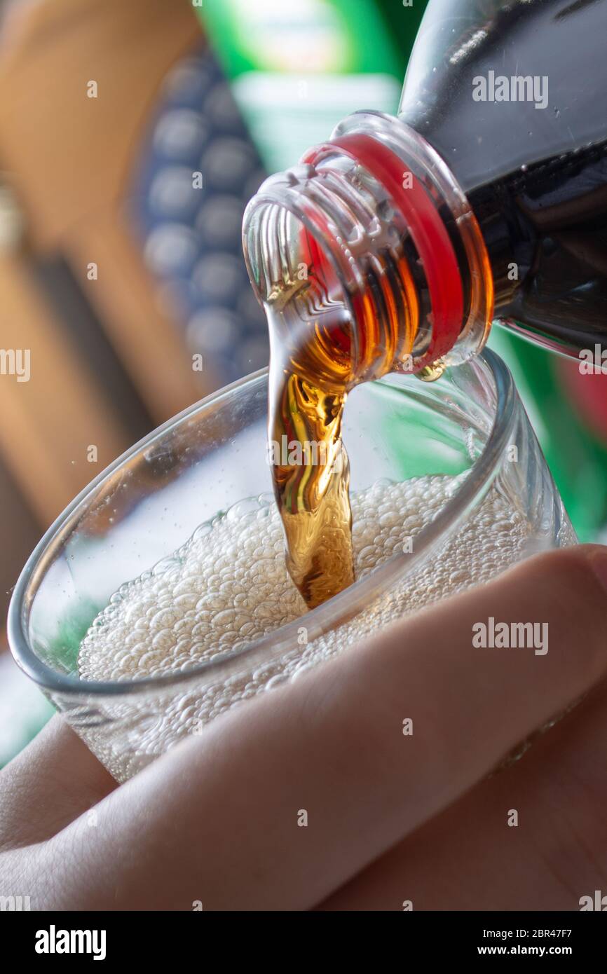 Pouring coke in the glass closeup. Bubbles in the glass Stock Photo