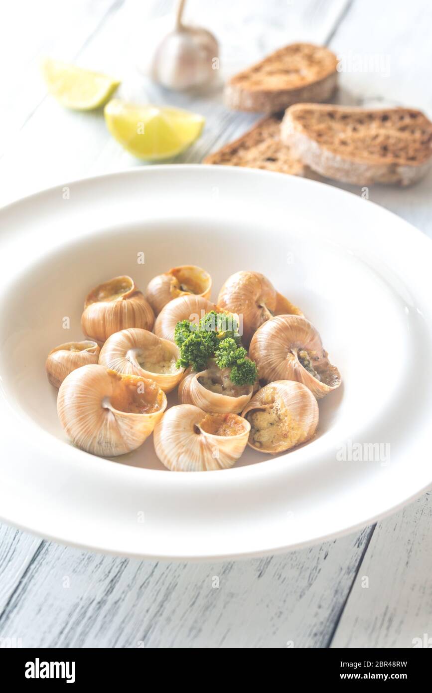 Portion of cooked snails Stock Photo Alamy