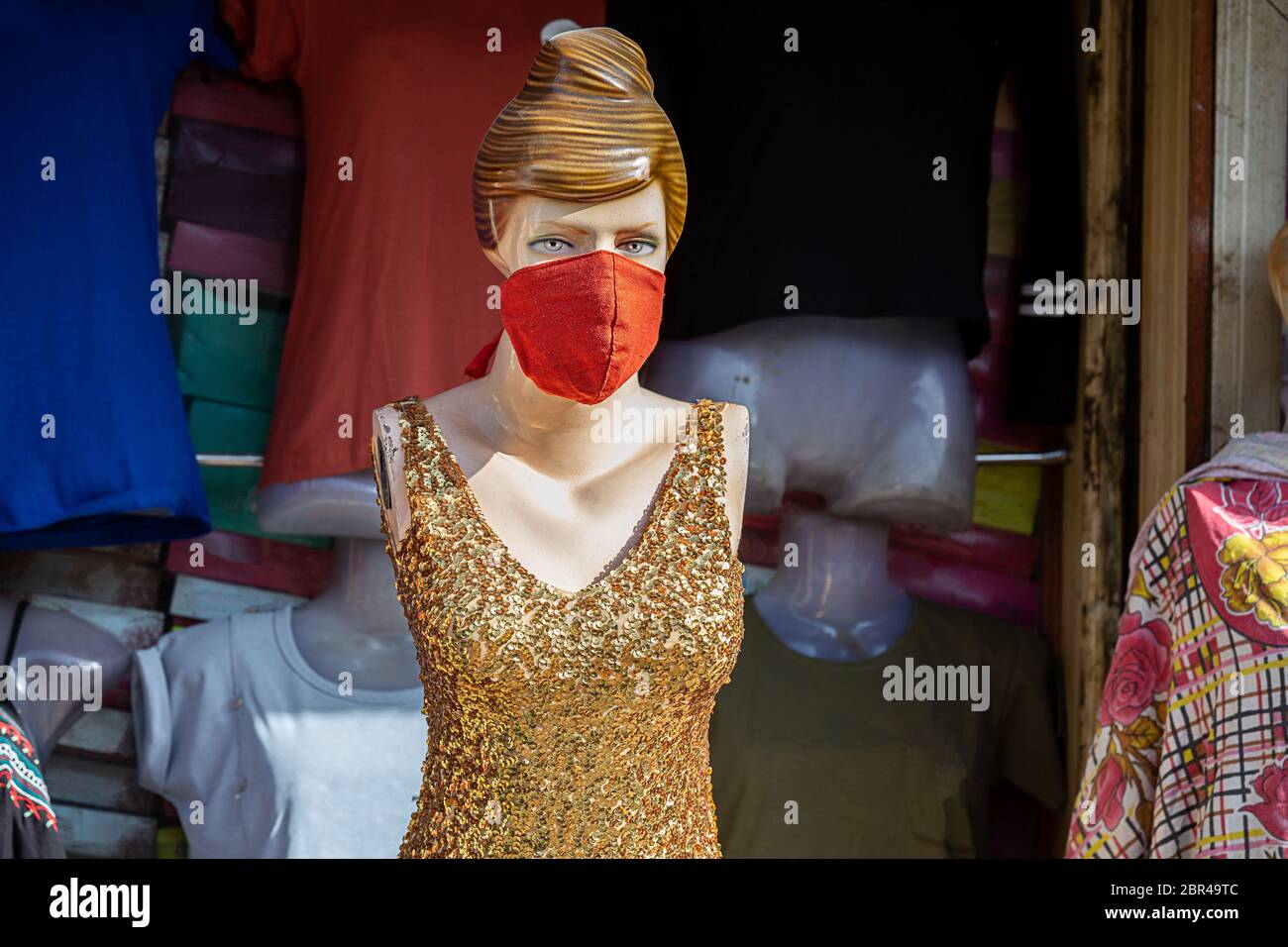 Female Mannequin with mask on face. Shops are reopening after lock down restrictions due to the covid-19 pandemic, back to normal life with few safety Stock Photo