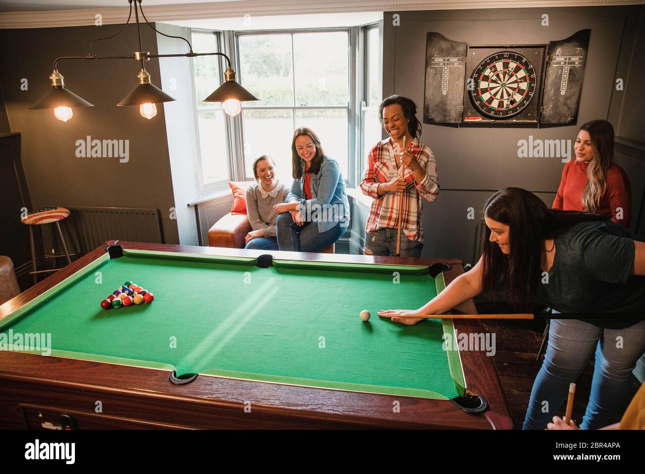 Billiards game. young friends playing pool together Stock Photo - Alamy