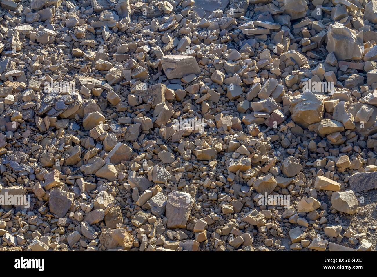 sunny illuminated full frame broken stones background Stock Photo