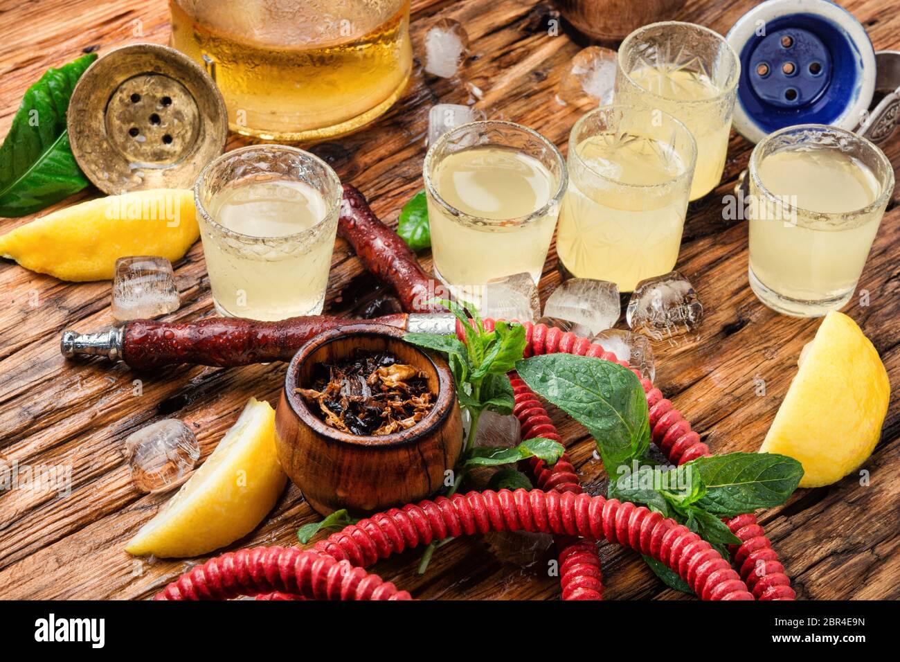 Smoking shisha and glasses with alcoholic limoncello.Hookah and alcohol Stock Photo